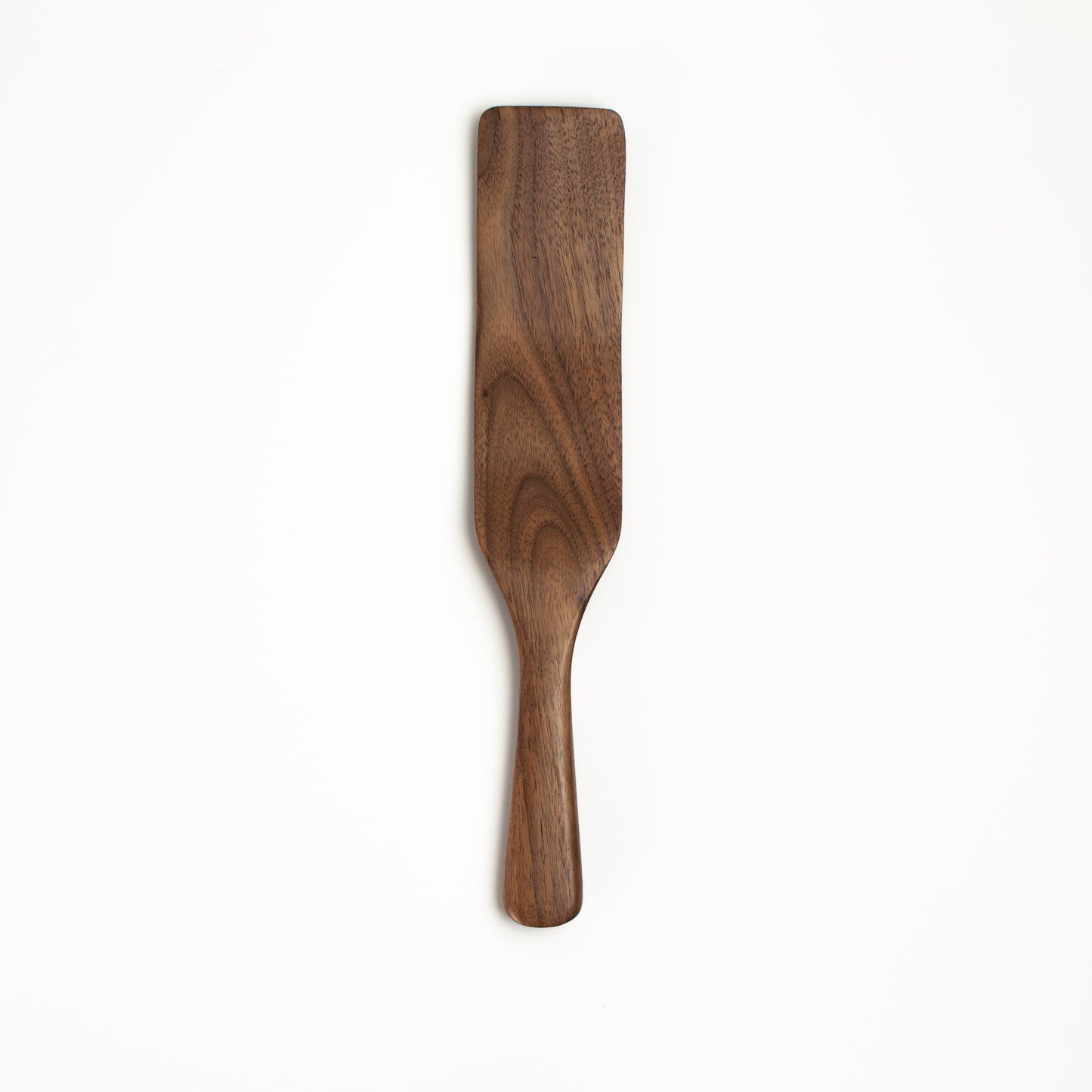 Walnut wooden spatula on a white background
