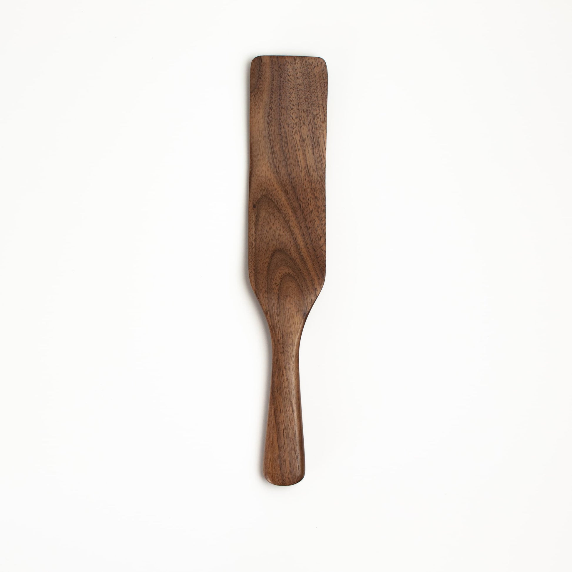 Walnut wooden spatula on a white background