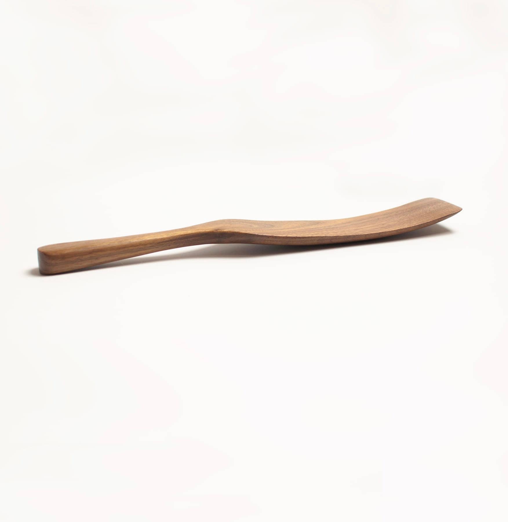 Walnut wooden spatula on a white background